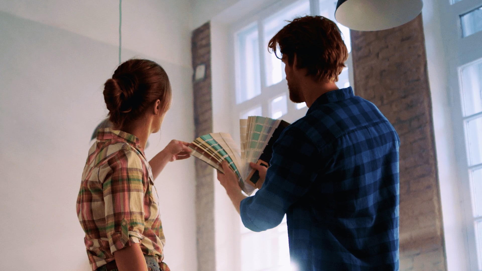 Couple looking at paint swatches in home