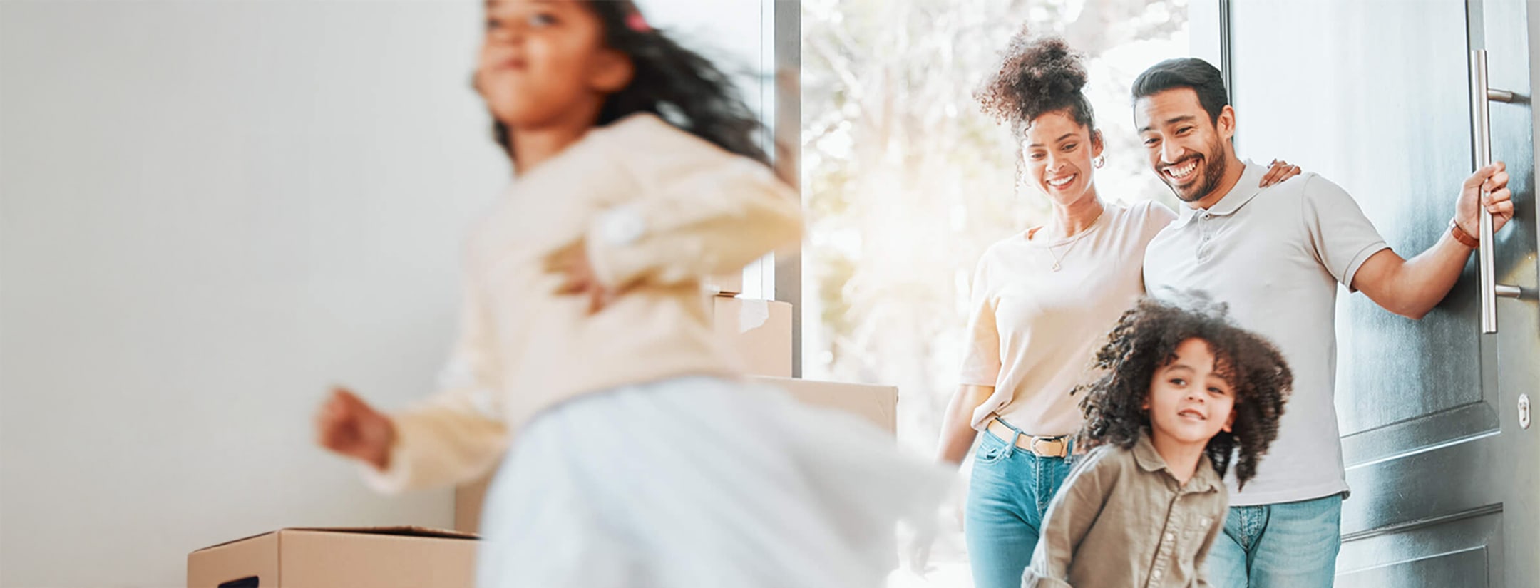 Parents and children entering a new house