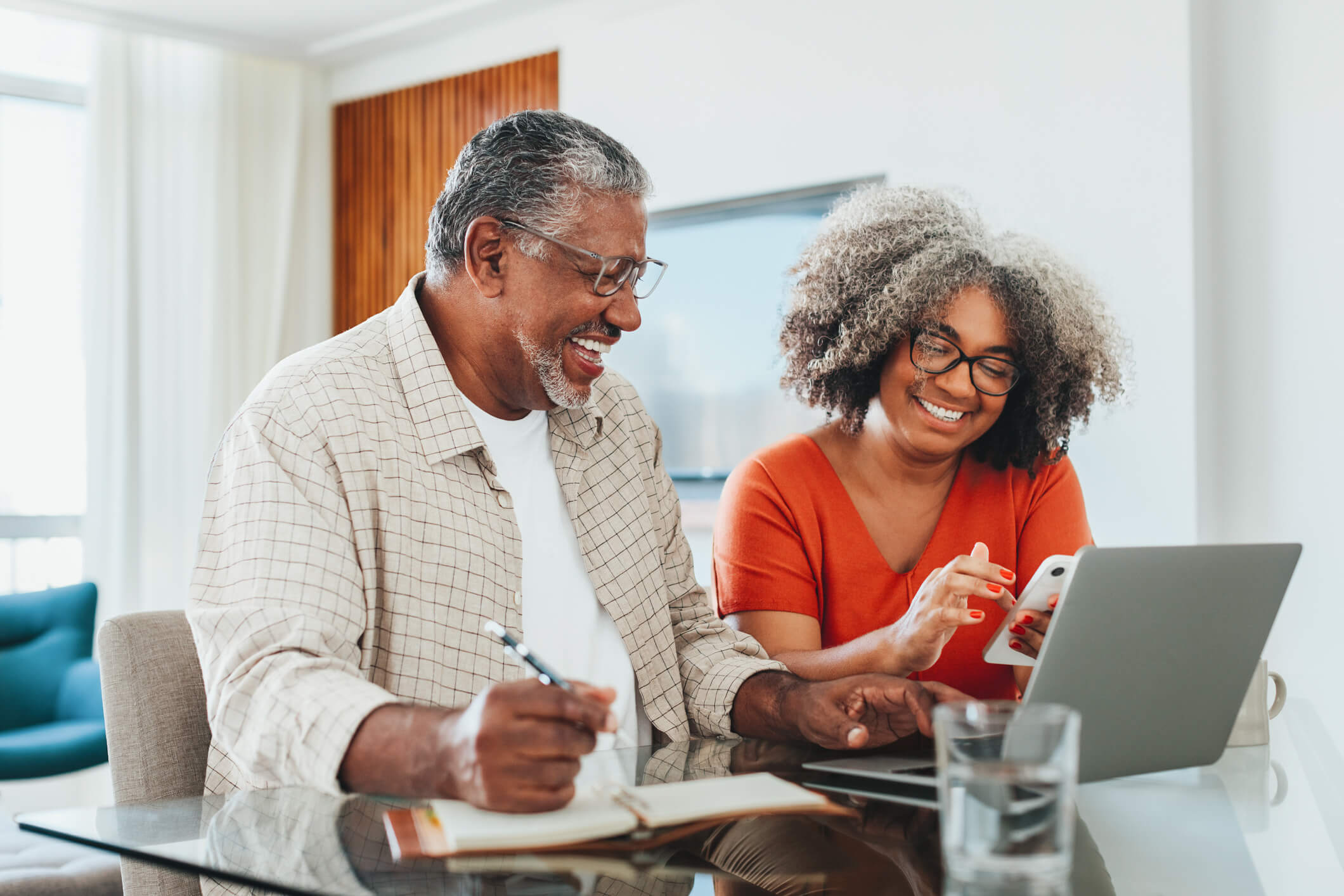 Couple banking on phone and laptop